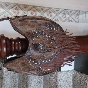 Western style concealed carry handbag.  Medium size, leather fringe.